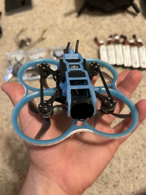 Second Pavo20 with a blue frame, held in a hand
