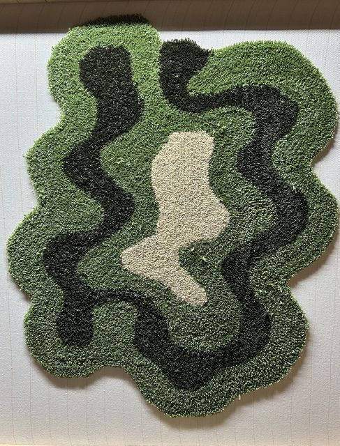 Fully tufted rug still on the frame